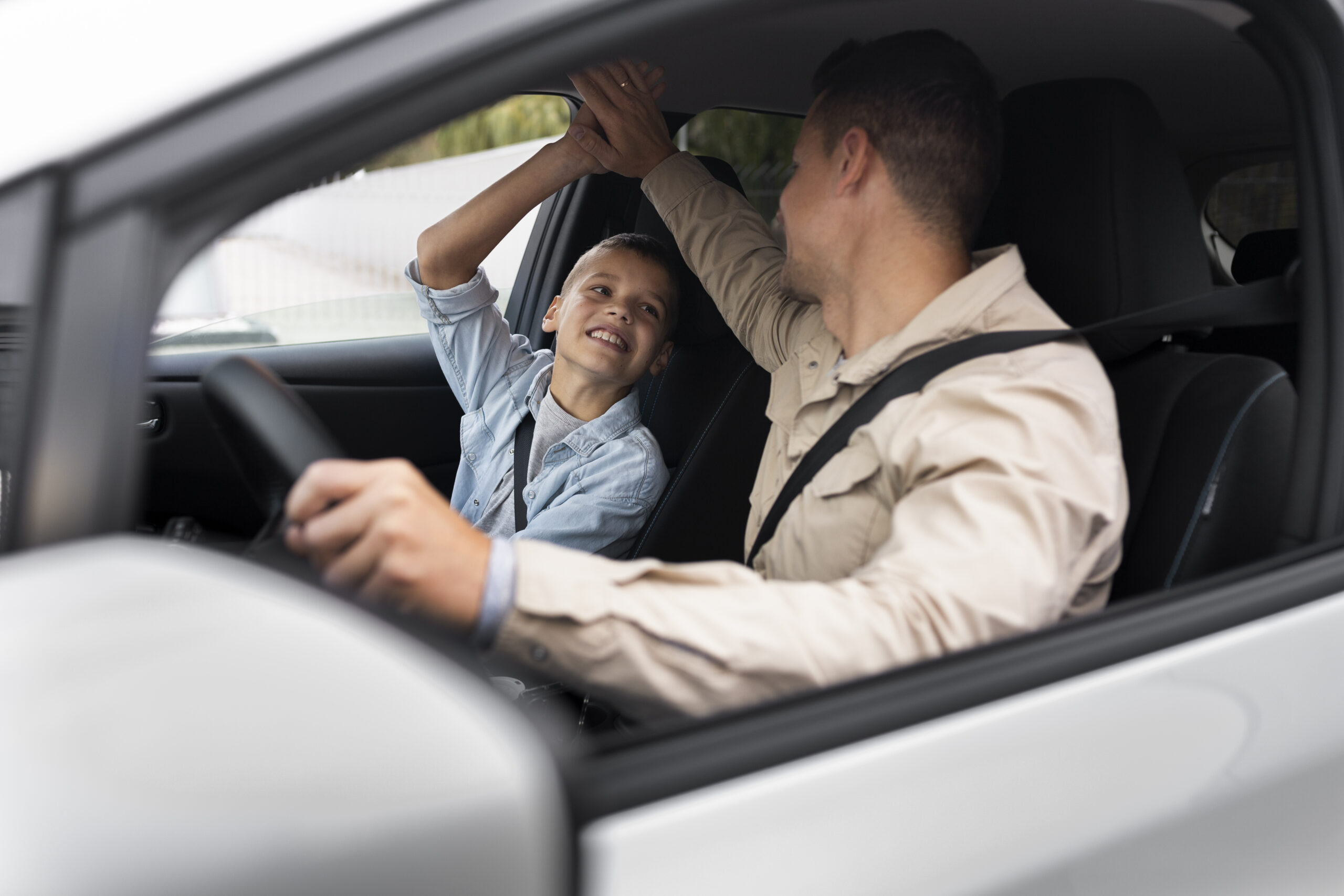 boy-and-dad-near-an-electric-car